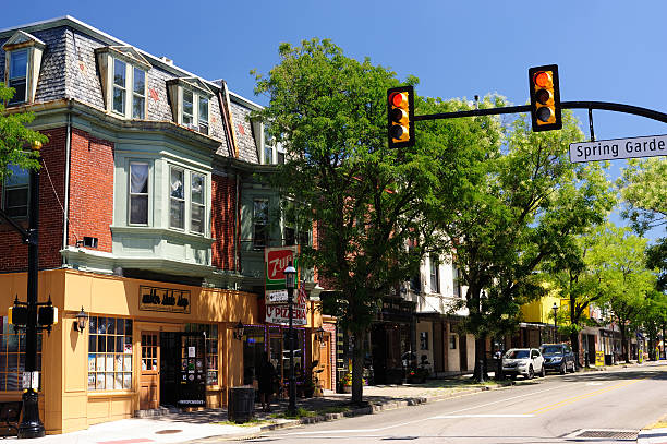 Ambler, USA - July 25, 2015. Street view on Butler Avenue in downtown Ambler with a lady walking on sidewalk. Ambler is a historic small town north of Philadelphia in Pennsylvania.